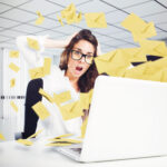 image of envelopes representing email flying out of laptop; woman with shocked face