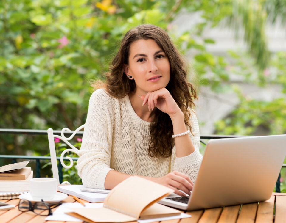 professional woman working on laptop with satisfied smil