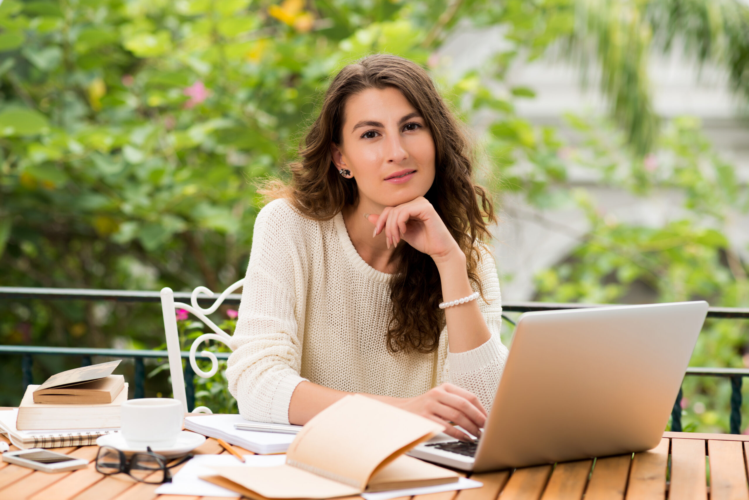 professional woman working on laptop with satisfied smil
