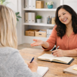 collaborative conversation between two women at wooden desk